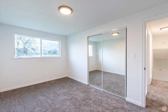 2389 S 4300 W, Taylor, UT 84401 - unfurnished bedroom with a closet, baseboards, carpet flooring, and visible vents