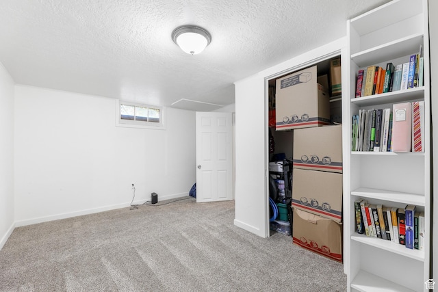 recreation room with baseboards, carpet, and a textured ceiling