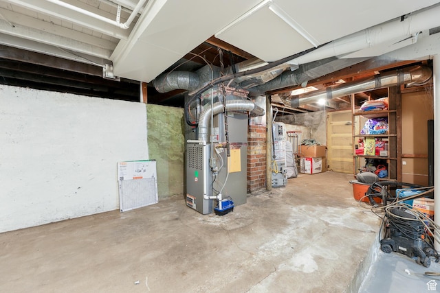 unfinished basement featuring heating unit
