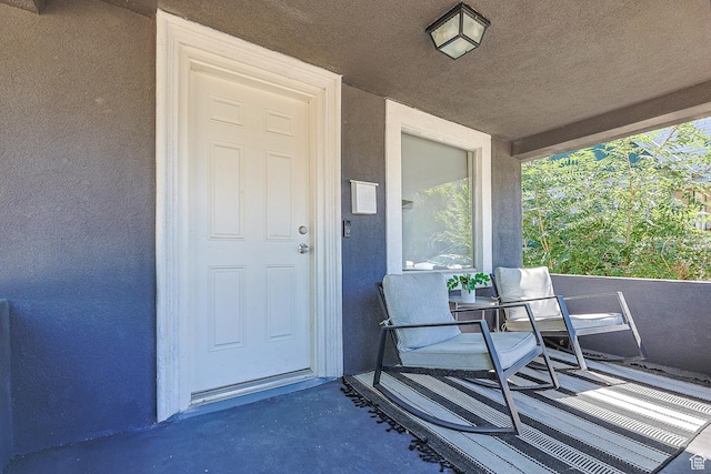 doorway to property featuring stucco siding