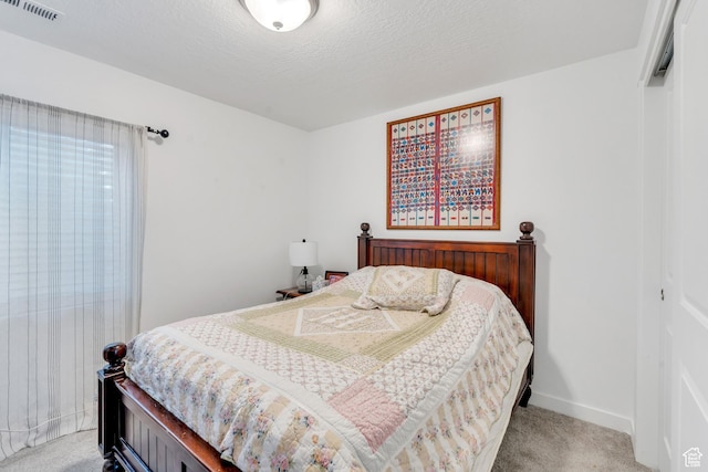 bedroom with baseboards, visible vents, and carpet floors