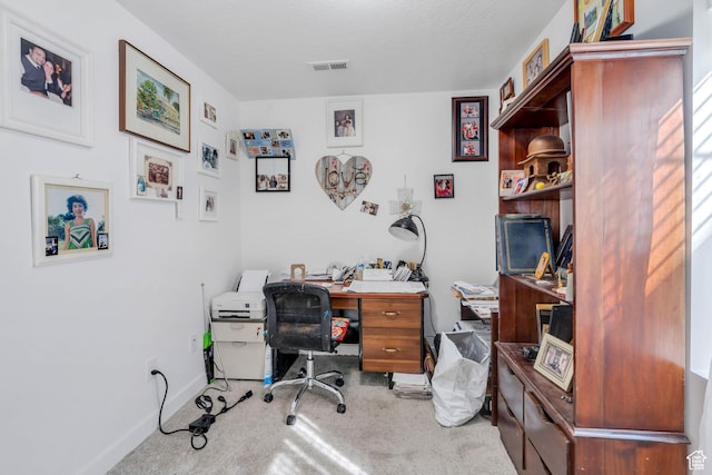 carpeted home office with baseboards and visible vents