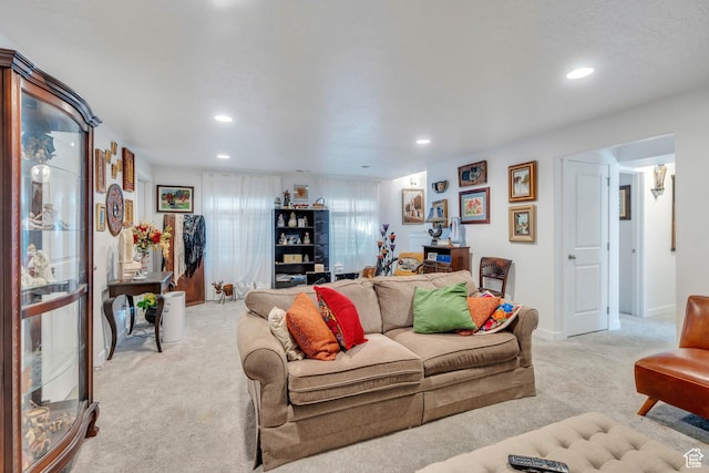 living room with recessed lighting and light carpet