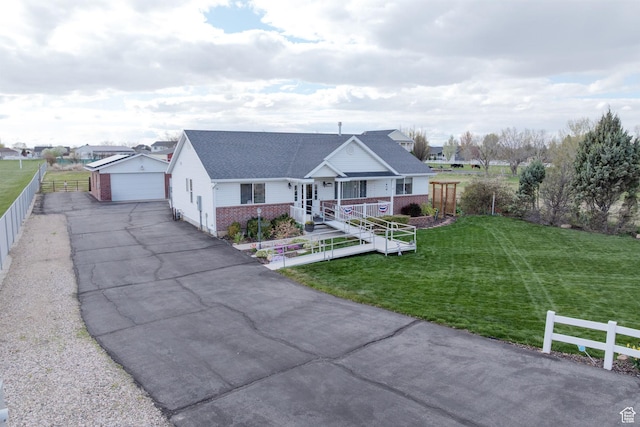 4577 S 4300 W, West Haven, UT 84401 - view of front of house featuring an outbuilding, a front lawn, fence, brick siding, and a garage
