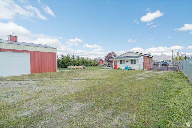 4577 S 4300 W, West Haven, UT 84401 - view of yard with an outdoor structure, a detached garage, and fence