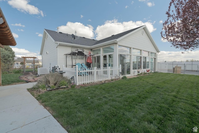 4577 S 4300 W, West Haven, UT 84401 - rear view of house featuring a yard, a sunroom, a shingled roof, and a fenced backyard