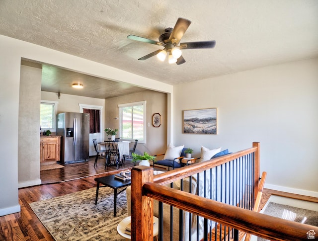 630 E 2550 N, North Ogden, UT 84414 - living room featuring a textured ceiling, a ceiling fan, baseboards, and dark wood-style floors