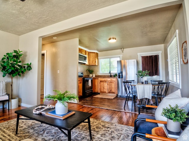 630 E 2550 N, North Ogden, UT 84414 - living room with baseboards, a textured ceiling, and dark wood finished floors