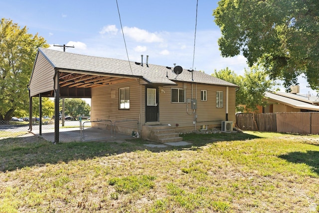 630 E 2550 N, North Ogden, UT 84414 - rear view of house with fence, a lawn, a shingled roof, and central AC
