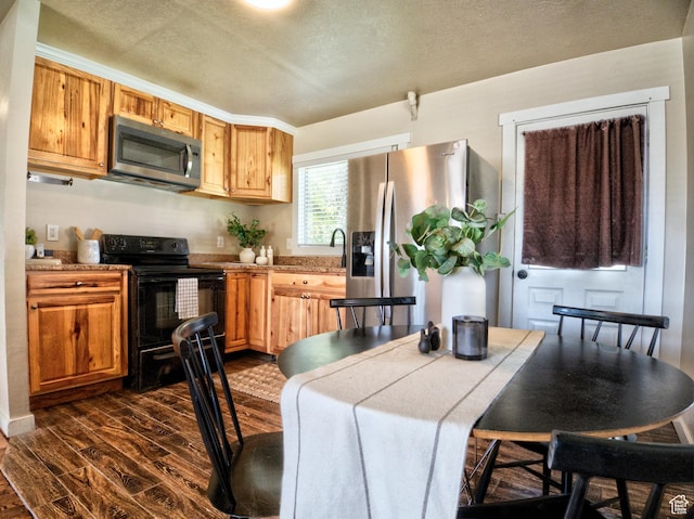 630 E 2550 N, North Ogden, UT 84414 - kitchen featuring stainless steel appliances, a sink, a textured ceiling, dark wood-style flooring, and light countertops