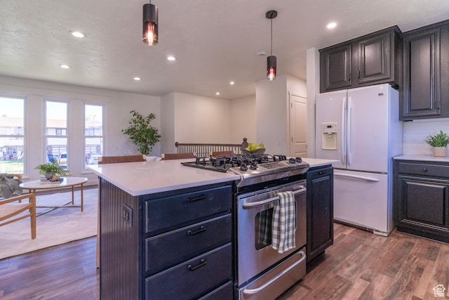 kitchen featuring white fridge with ice dispenser, light countertops, dark wood-style floors, and gas stove
