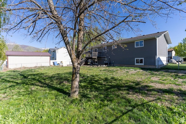 view of yard featuring fence, stairs, and a wooden deck