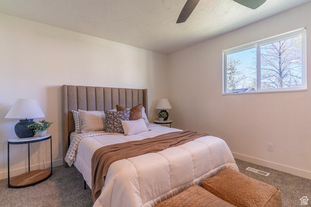 carpeted bedroom featuring visible vents, ceiling fan, and baseboards