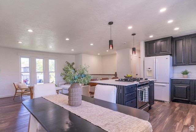 dining space with baseboards, recessed lighting, and dark wood-style flooring
