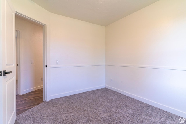 carpeted spare room with baseboards