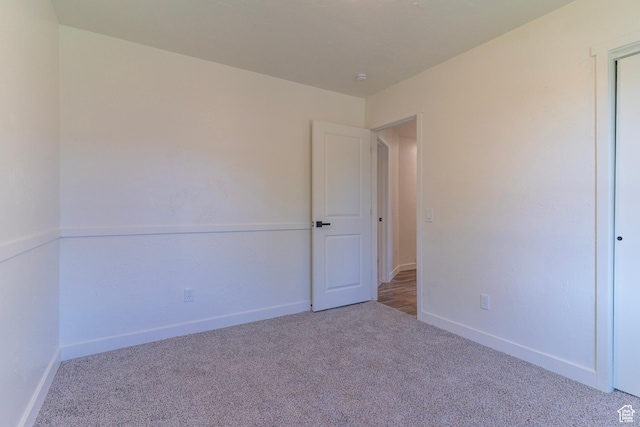 empty room with carpet floors and baseboards