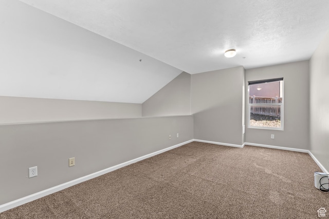 bonus room with carpet, lofted ceiling, and baseboards
