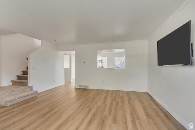 unfurnished living room featuring crown molding, stairs, visible vents, and light wood-style floors