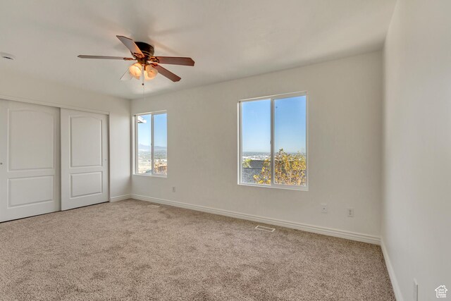 unfurnished bedroom featuring a closet, visible vents, carpet flooring, and baseboards