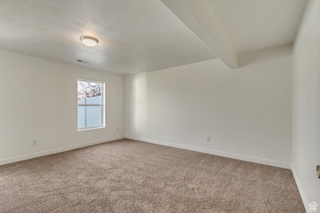 unfurnished room featuring baseboards and carpet flooring