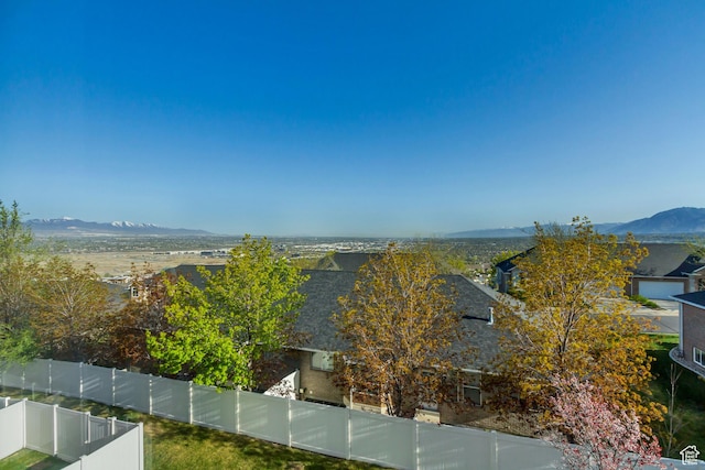 view of water feature featuring a fenced backyard and a mountain view