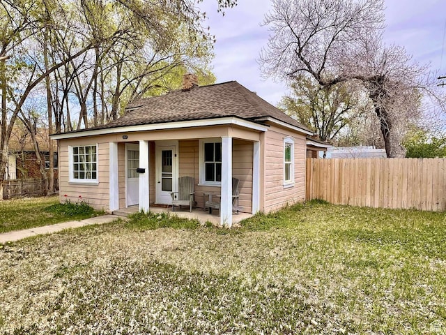 152 N 400 E, Vernal, UT 84078 - view of front of property with fence, a front lawn, a chimney, and roof with shingles