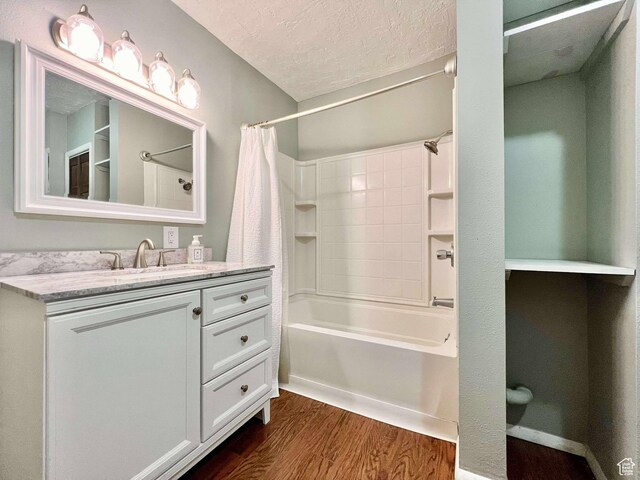 152 N 400 E, Vernal, UT 84078 - bathroom with vanity, shower / tub combo with curtain, wood finished floors, and a textured ceiling