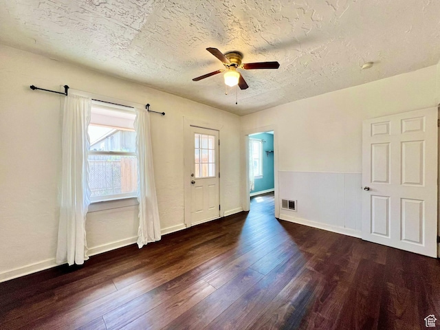 152 N 400 E, Vernal, UT 84078 - spare room featuring a textured ceiling, dark wood-style flooring, baseboards, visible vents, and ceiling fan
