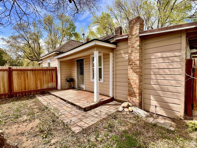 152 N 400 E, Vernal, UT 84078 - rear view of property featuring fence, a chimney, and roof with shingles
