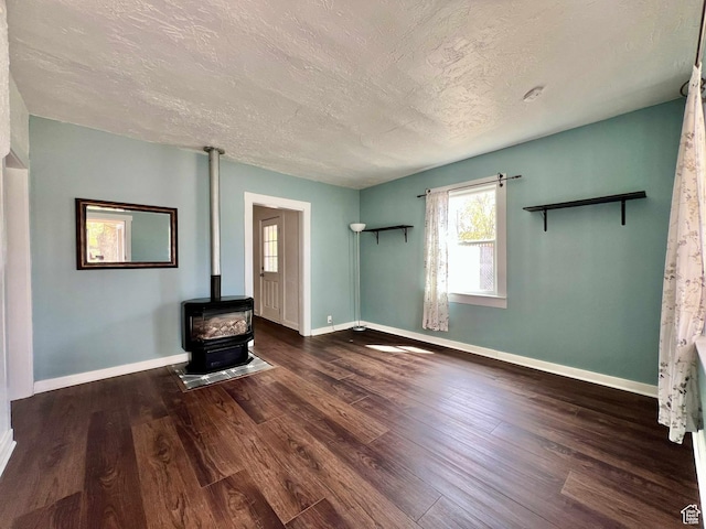 152 N 400 E, Vernal, UT 84078 - unfurnished living room featuring wood finished floors, a textured ceiling, and a wood stove