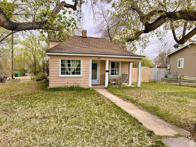 152 N 400 E, Vernal, UT 84078 - bungalow-style house featuring a front lawn, a shingled roof, a chimney, and fence