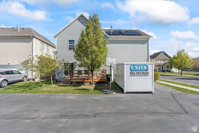 1521 W Kinloch Way, West Valley City, UT 84119 - exterior space with a front lawn, roof mounted solar panels, and a deck