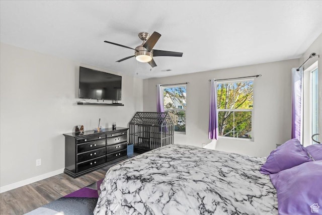1521 W Kinloch Way, West Valley City, UT 84119 - bedroom featuring baseboards, a ceiling fan, wood finished floors, and multiple windows