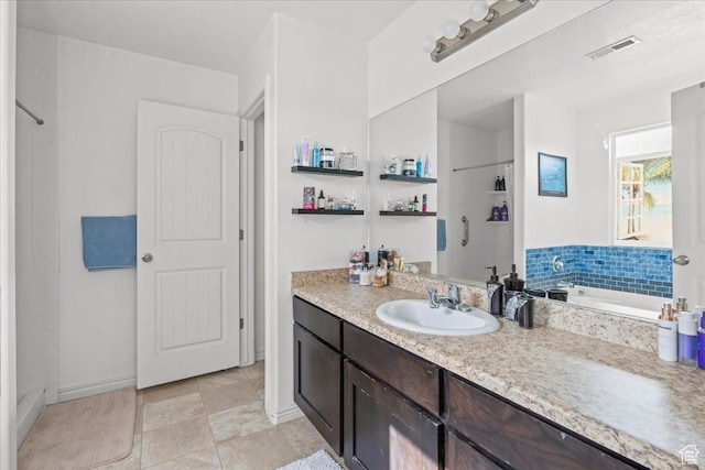 1521 W Kinloch Way, West Valley City, UT 84119 - full bathroom featuring visible vents, vanity, baseboards, a shower, and a tub