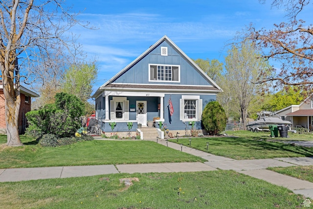 453 N 200 W, Brigham City, UT 84302 - bungalow-style house with a porch, board and batten siding, and a front yard