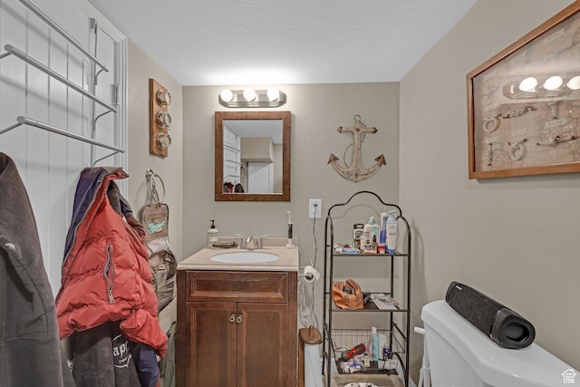 453 N 200 W, Brigham City, UT 84302 - half bathroom featuring a textured ceiling, toilet, and vanity