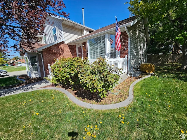 723 E 200 N, Orem, UT 84097 - view of home's exterior with brick siding, a lawn, and fence