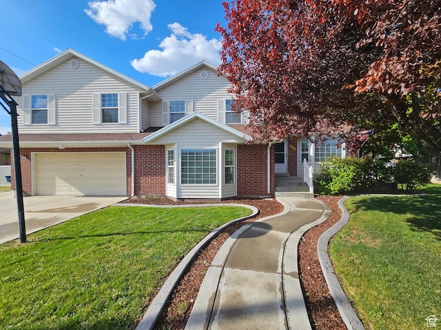 723 E 200 N, Orem, UT 84097 - townhome / multi-family property with an attached garage, a front yard, driveway, and brick siding