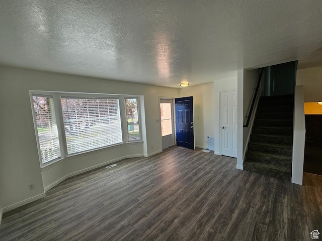 723 E 200 N, Orem, UT 84097 - unfurnished living room with baseboards, a textured ceiling, dark wood-style flooring, and stairs