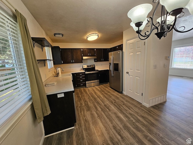 723 E 200 N, Orem, UT 84097 - kitchen with a sink, baseboards, dark wood-style floors, a notable chandelier, and stainless steel appliances