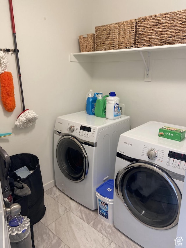 9372 N Scenic Mountain Dr W, Eagle Mountain, UT 84005 - laundry room with baseboards, marble finish floor, washer and clothes dryer, and laundry area