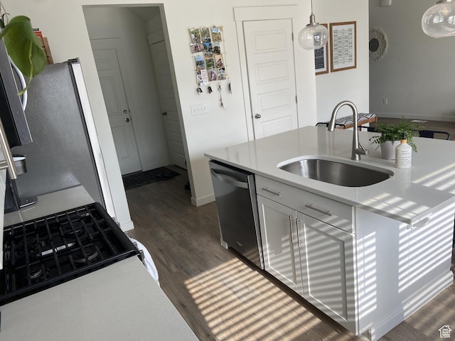 9372 N Scenic Mountain Dr W, Eagle Mountain, UT 84005 - kitchen featuring dark wood finished floors, light countertops, stainless steel dishwasher, a sink, and decorative light fixtures