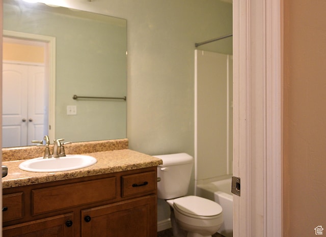 bathroom with toilet, vanity, and tub / shower combination