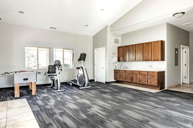 workout room featuring high vaulted ceiling, baseboards, dark colored carpet, and visible vents
