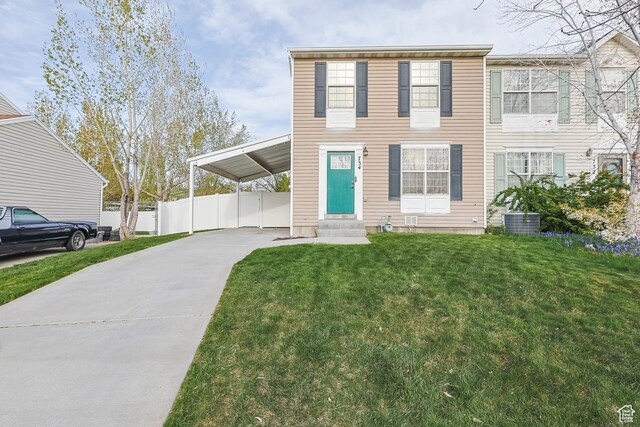 734 N 170 W, Tooele, UT 84074 - view of front of house with a front lawn, an attached carport, driveway, fence, and entry steps