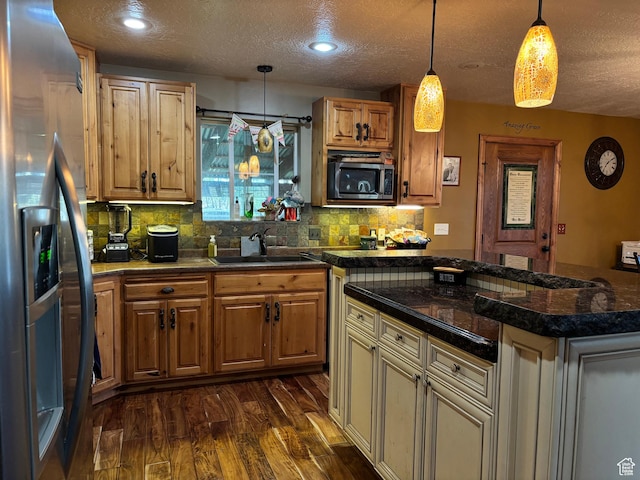 9762 S 3350 W, Payson, UT 84651 - kitchen with stainless steel appliances, a textured ceiling, a sink, backsplash, and dark wood-type flooring