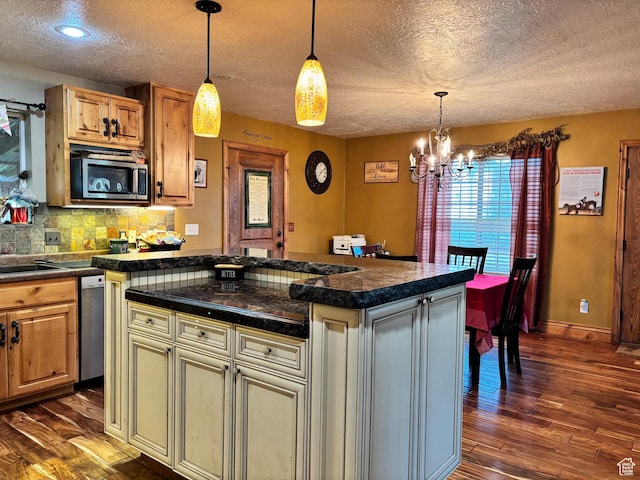 9762 S 3350 W, Payson, UT 84651 - kitchen with tile counters, a chandelier, a textured ceiling, appliances with stainless steel finishes, and dark wood-style flooring