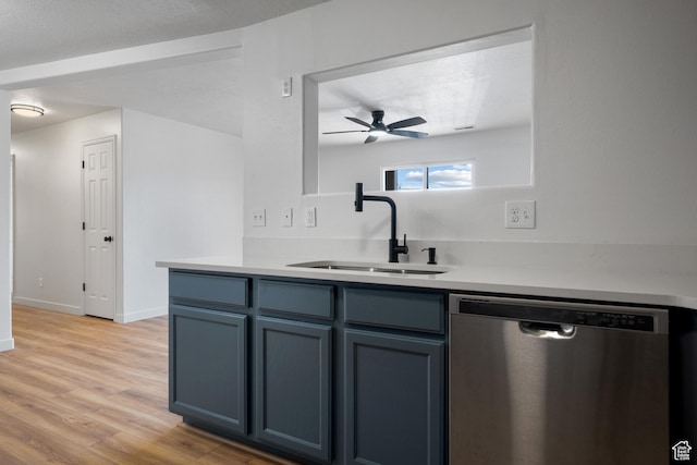 kitchen with light countertops, dishwasher, a ceiling fan, a sink, and light wood-type flooring