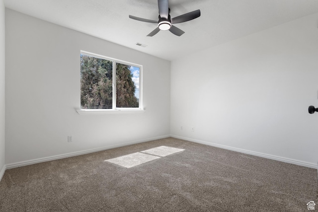 empty room featuring visible vents, baseboards, a ceiling fan, and carpet flooring