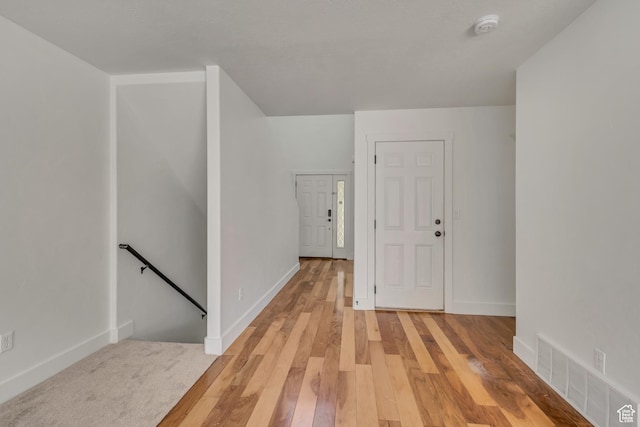 2074 S Orchard Dr, Bountiful, UT 84010 - hall with baseboards, light wood-style flooring, visible vents, and an upstairs landing